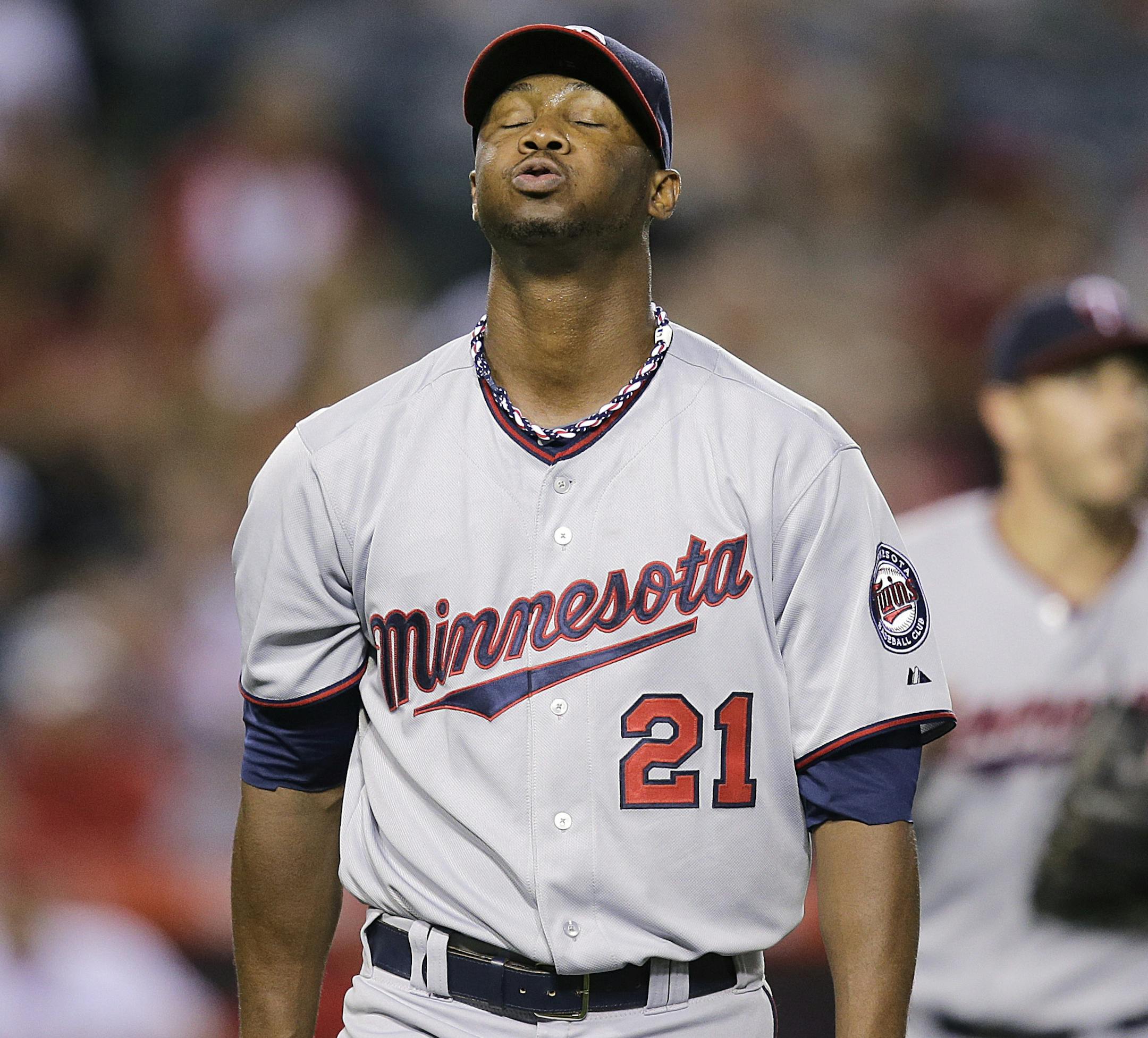 Minnesota Twins starting pitcher Samuel Deduno takes a breath as he walks off the field after the third inning of a baseball game against the Los Angeles Angels on Monday, July 22, 2013, in Anaheim, Calif. (AP Photo/Jae C. Hong)