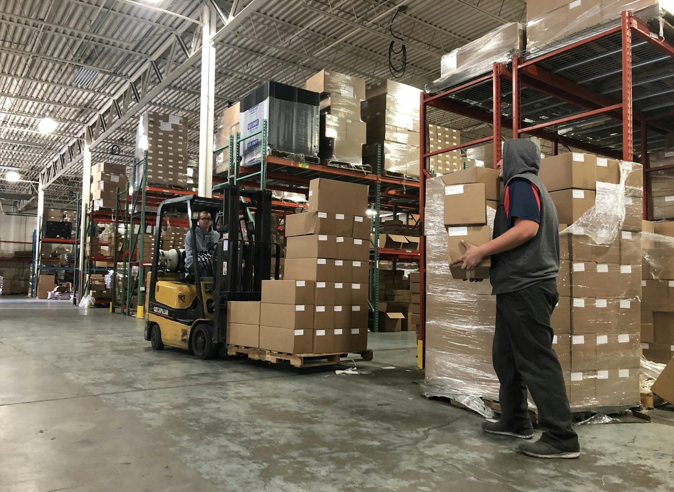 A worker fills shelves at RPM Inc.'s distribution center in Savage. The company makes moisture trapping mats for use in cars, with pets and under gas grills. It now has seven Drymate Mats on shelves of Walmart stores after taking part in several Open Call events to pitch their product to Walmart product managers. The father-son team made their first trip to Bentonville, Ark. for the pitchfest in 2014.