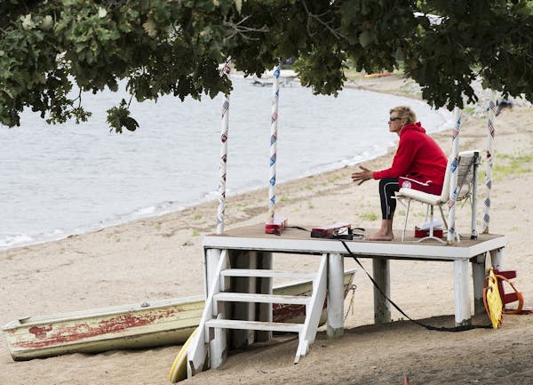 Lifeguard Jaeger Jergenson, 15, kept watch at an empty beach on Lake Minnewaska in Glenwood, Minn., on Wednesday.