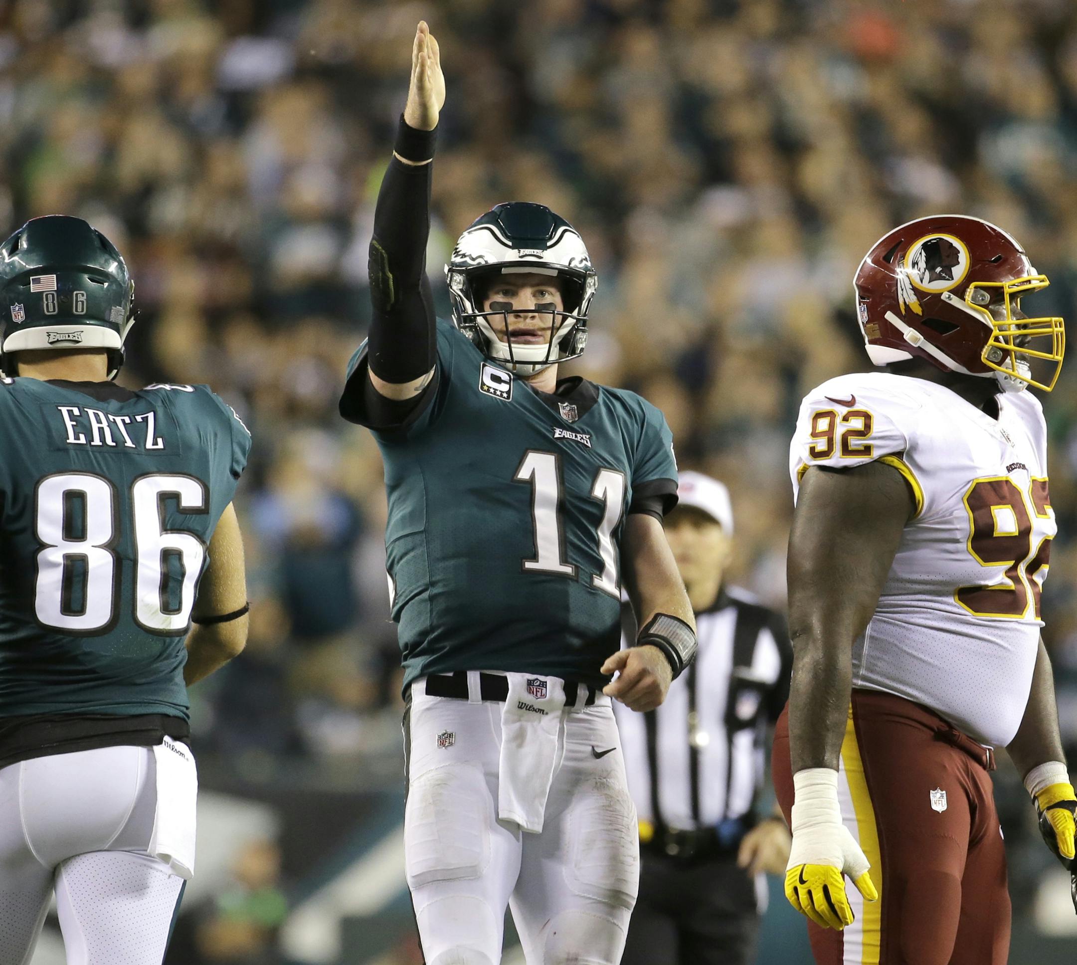 FILE - In this Monday, Oct. 23, 2017, file photo, Philadelphia Eagles quarterback Carson Wentz (11) gestures after scrambling for yardage against the Washington Redskins during the second half of an NFL football game in Philadelphia. Wentz and the Philadelphia Eagles are the talk of the NFL following a surprising 6-1 start and impressive victories in consecutive prime-time games. (AP Photo/Michael Perez, File)