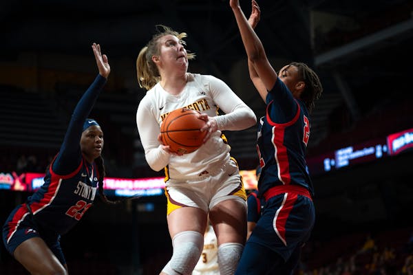 Minnesota center Sophie Hart (52) prepares to shoot the basketball at the game against Stony Brook University at the William Arena in Minneapolis on S