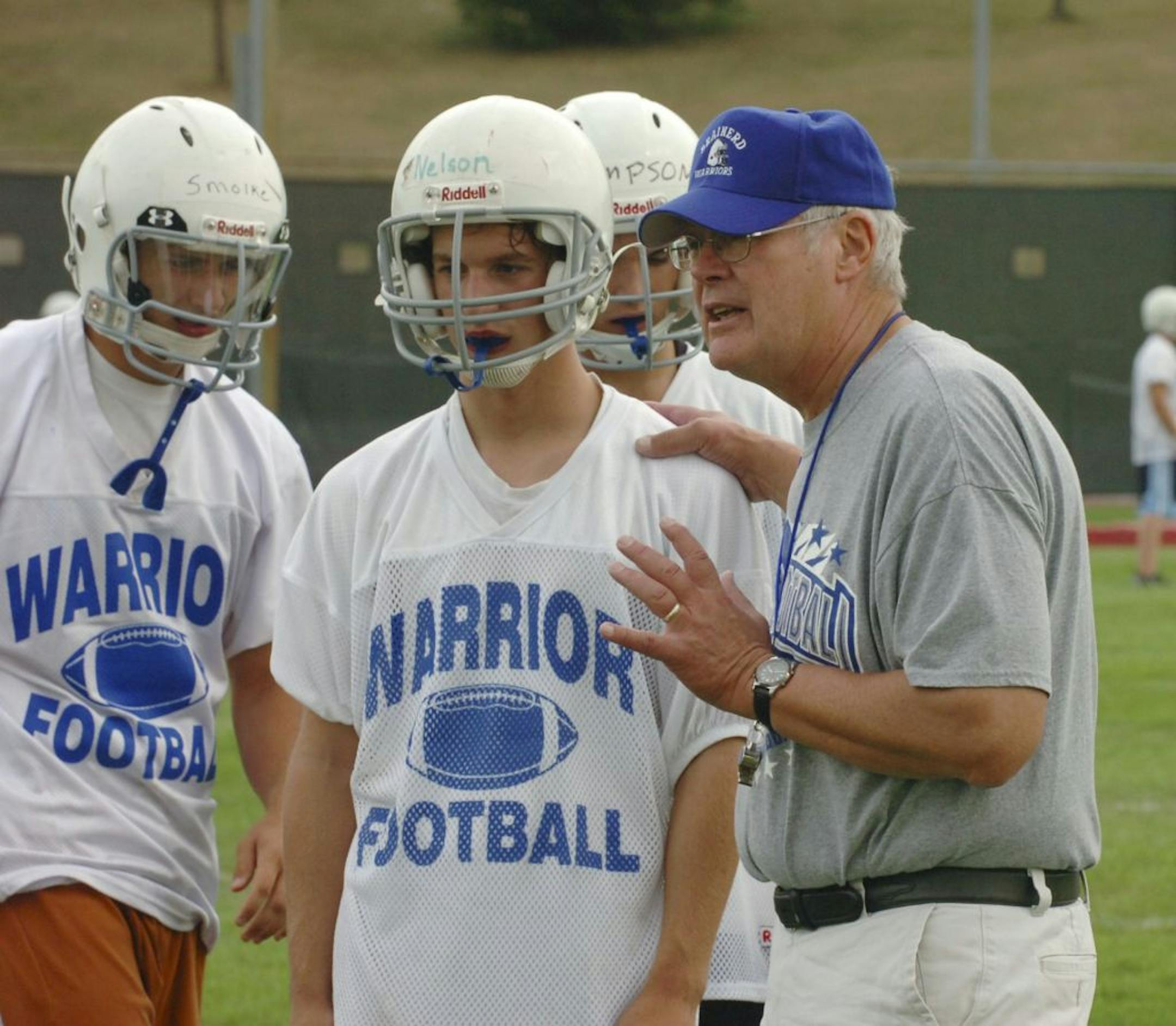 Brainerd football coach Ron Stolski talked with players on the first day of practice in 2007.