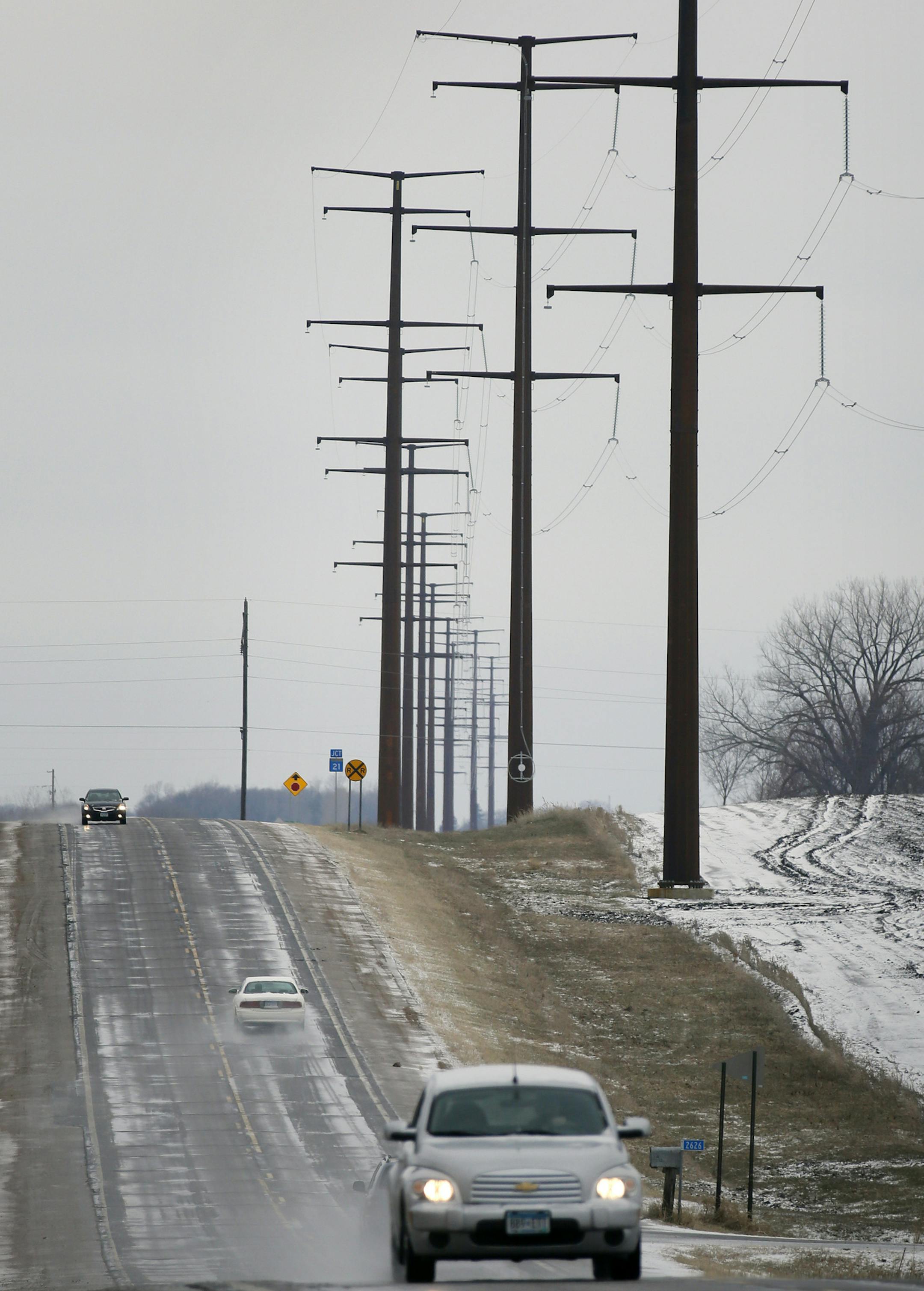 One year after he thought he triumphed with overwhelming bipartisan support in the Minnesota Legislature, Dave and Florence Minar, owners of one of the state's top organic farms, finds themselves in court next week, fighting still to exert their rights over the powerline company that has run its massive lines across their land. Here, Power Lines run along side the road near Cedar Summit Farm. ] BRIAN PETERSON &#x2022; brian.peterson@startribune.com New Prague, MN 4/17/2014 ORG XMIT: MIN140417145