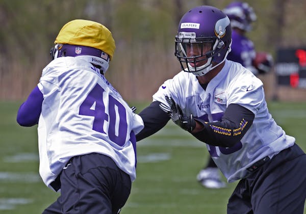(left to right) Kendall James and Anthony Barr worked on drills during the Vikings Rookie Mini Camp at Winter Park on 5/16/14.] Bruce Bisping/Star Tri