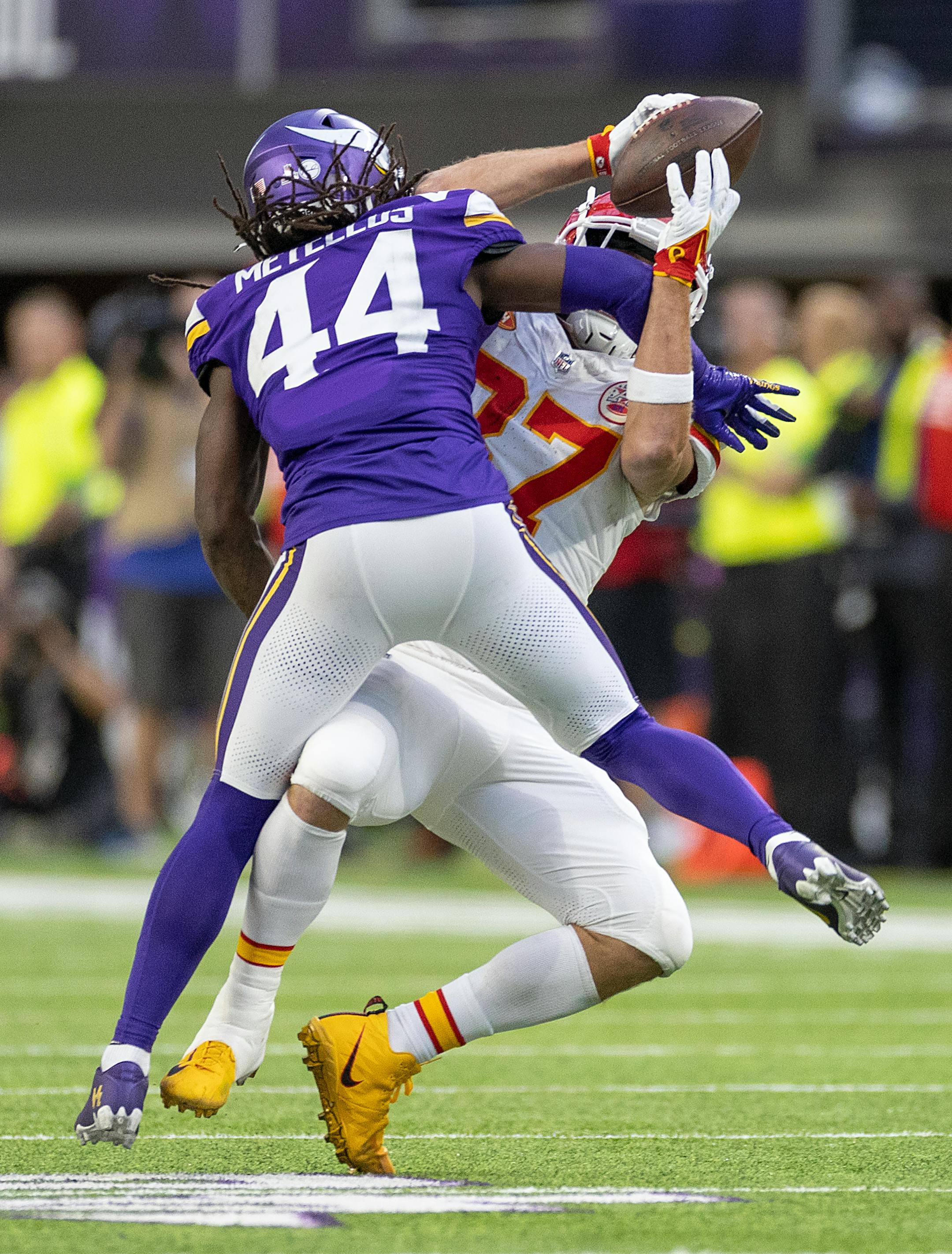 Vikings safety Josh Metellus (44) tackles Chiefs tight end Travis Kelce (87) in the third quarter. That ball was given back to Kansas City in this play.