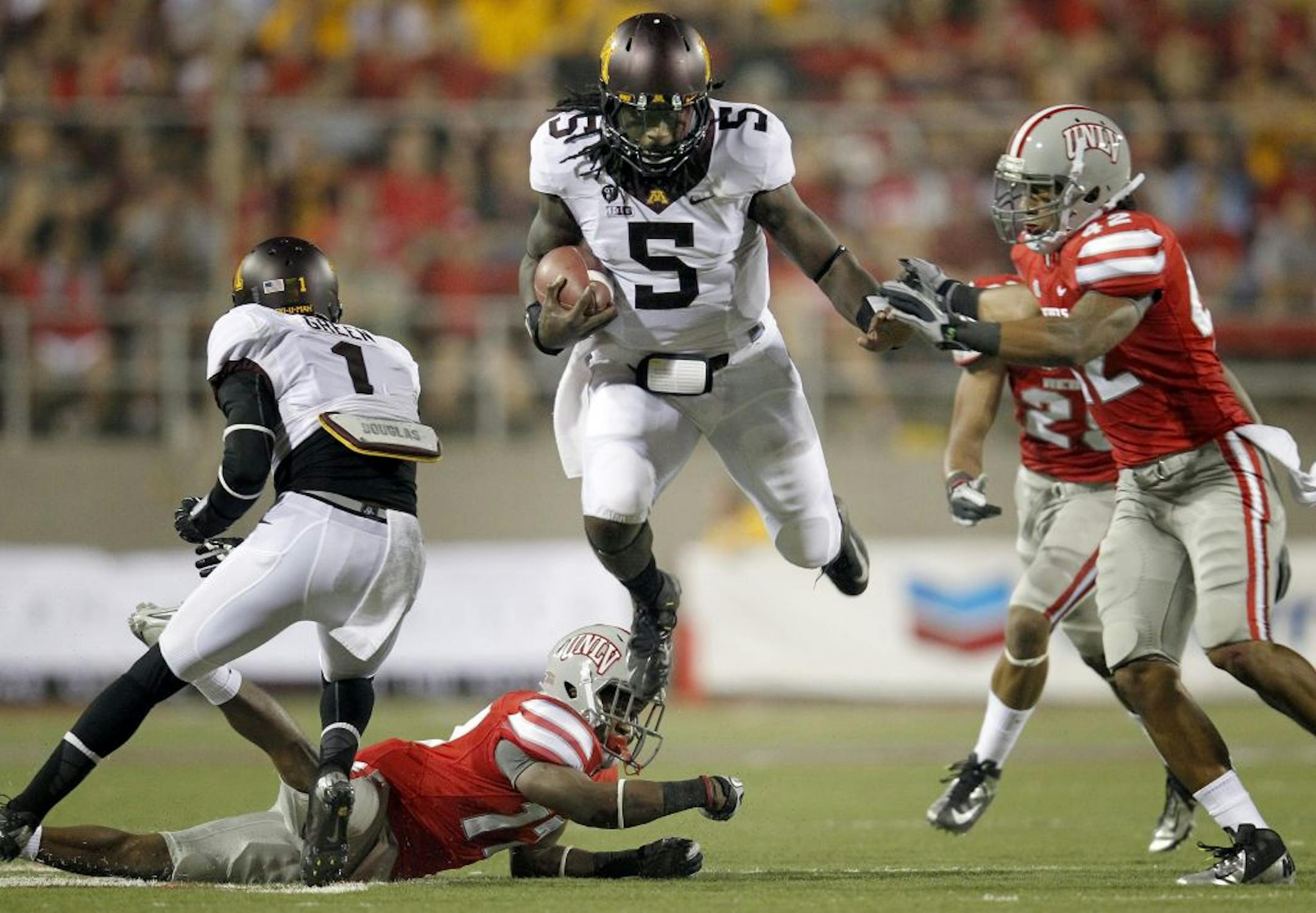 Minnesota quarterback MarQueis Gray (5) during a run in the second quarter.