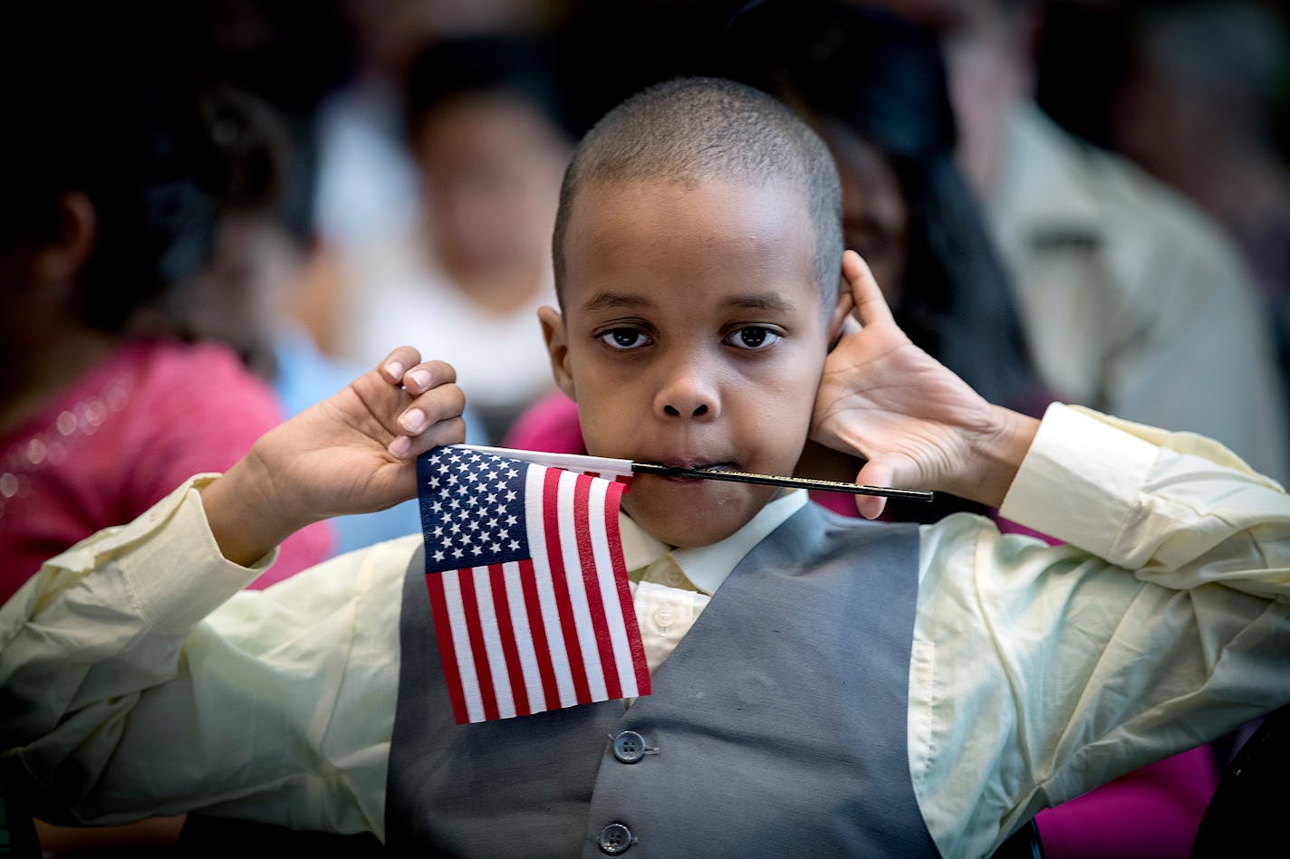 Abdirahman Ahmed listened to speakers during a U.S. Citizenship and Immigration Services citizenship ceremony at the Minnesota Children's Museum, Friday, July 21, 2017 in St. Paul, MN. Some of the children were adopted by U.S. citizen parents while others got their citizenship when their immigrant parents naturalized. ] ELIZABETH FLORES � liz.flores@startribune.com