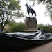 City workers prepare to drape a tarp over the statue of Confederate General Stonewall Jackson in Justice park in Charlottesville, Va., Wednesday, Aug.