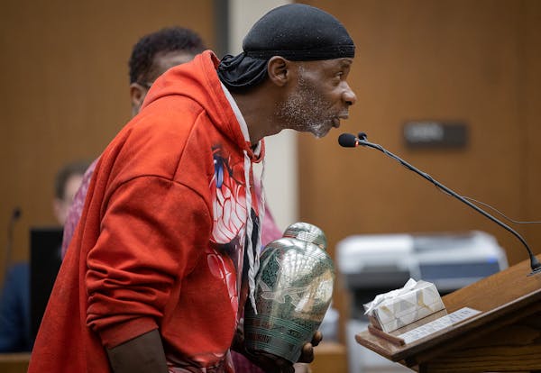 Leneal Frazier's uncle Dwayne Jackson shows the urn to Judge Tamara Garcia during the victim impact statement portion of the sentencing of ex-Minneapo