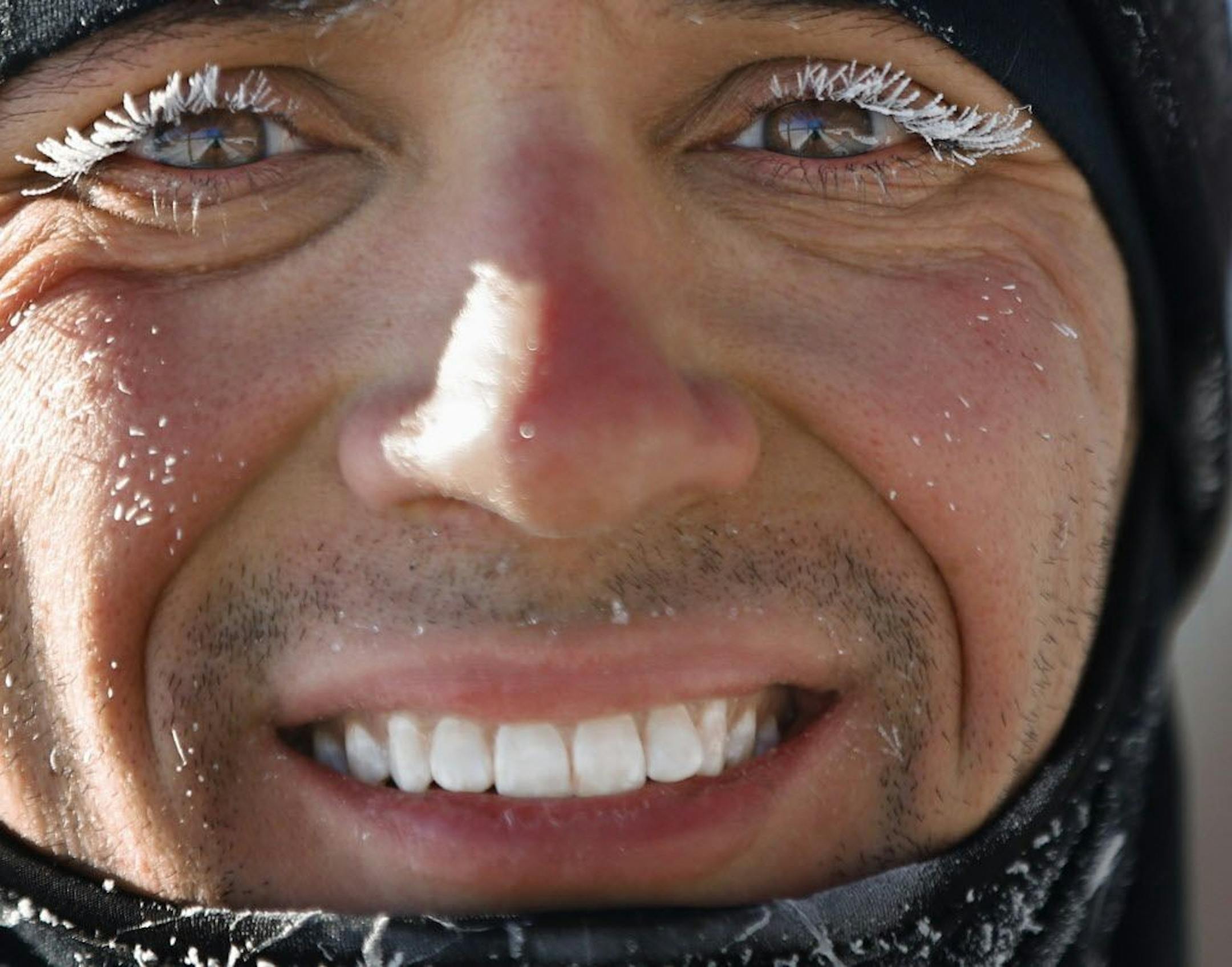 At Lake Harriet in Minneapolis, runner Jack Delehanty braved the -12 temperatures to get a 10-mile jaunt in the the coldest day so far this winter. "The sun helps a lot, " says the cheerful runner of the temperature.