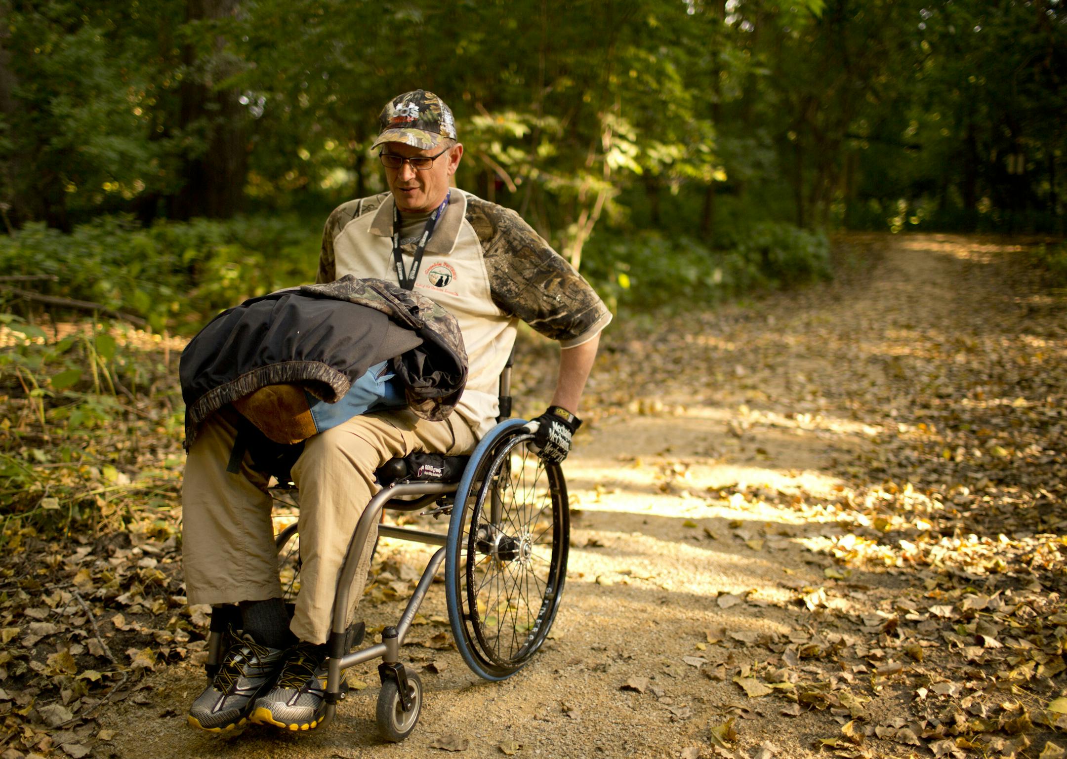 Capable Partners has been helping disabled people hunt and fish for years. Dave Guzzi and an able-bodied friend, Jayme Welsh, hunted deer Thursday evening, September 26, 2013 in a new blind area within the Minnesota Valley National Wildlife Refuge in Bloomington. With his gear in his lap, Dave Guzzi wheeled the short distance from his vehicle to the new hunting platform. ] JEFF WHEELER ‚Ä¢ jeff.wheeler@startribune.com