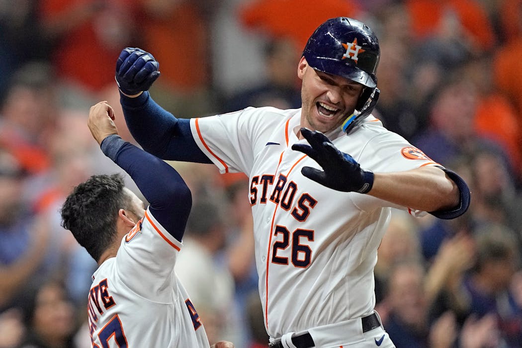 The Astros’ Trey Mancini (26) celebrated with teammate Jose Altuve after hitting a two-run homer against the Twins during the sixth inning. Altuve also homered Wednesday in Houston’s 5-3 victory.