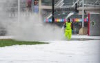 Workers hosed off snow and ice inside Target Field.