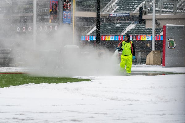 Workers hosed off snow and ice inside Target Field.