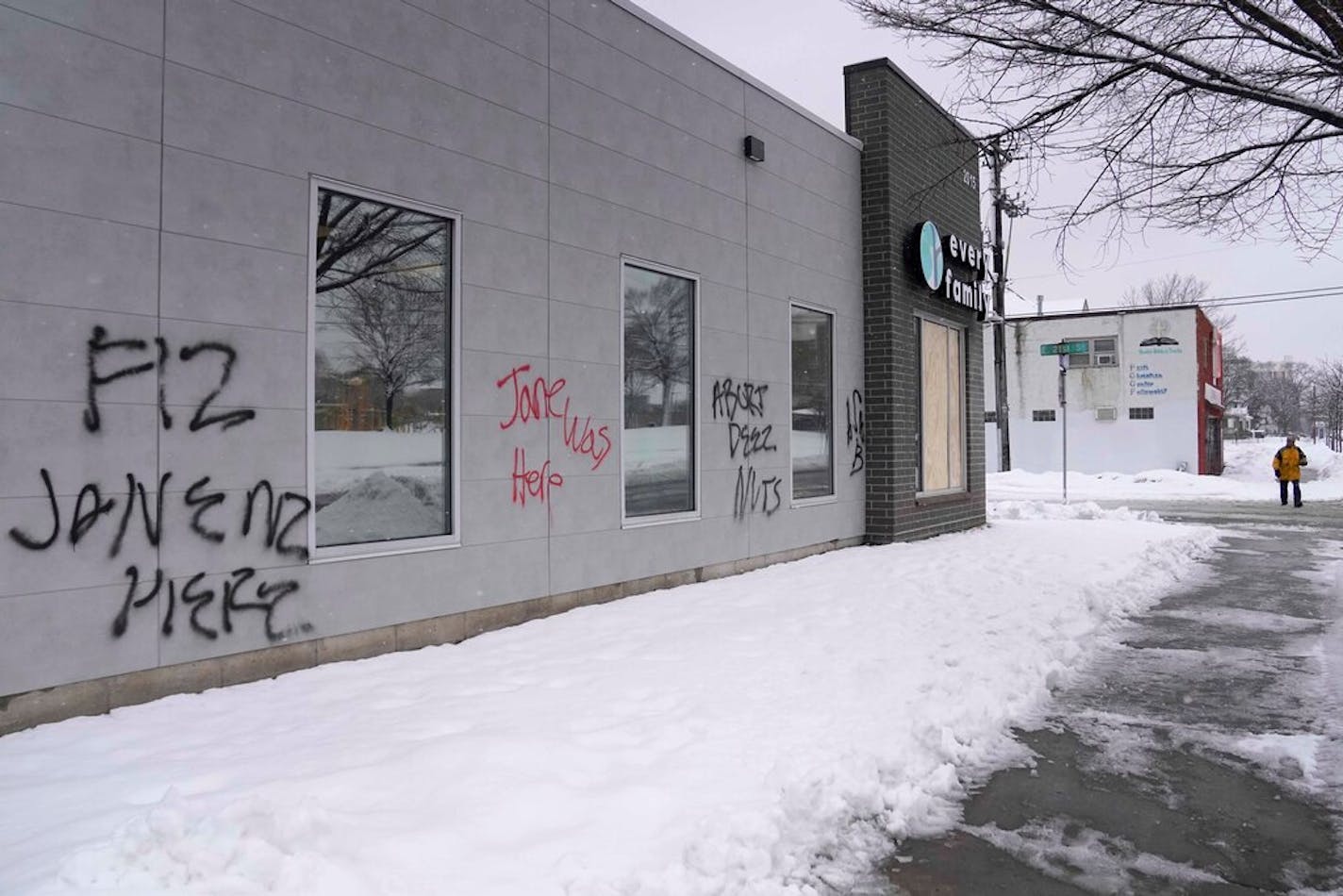 First Care Pregnancy Center, a counseling center for women, was recently tagged with graffiti and some windows, presumably broken, are now boarded up Monday, March 6, 2023 in Minneapolis, Minn. ]