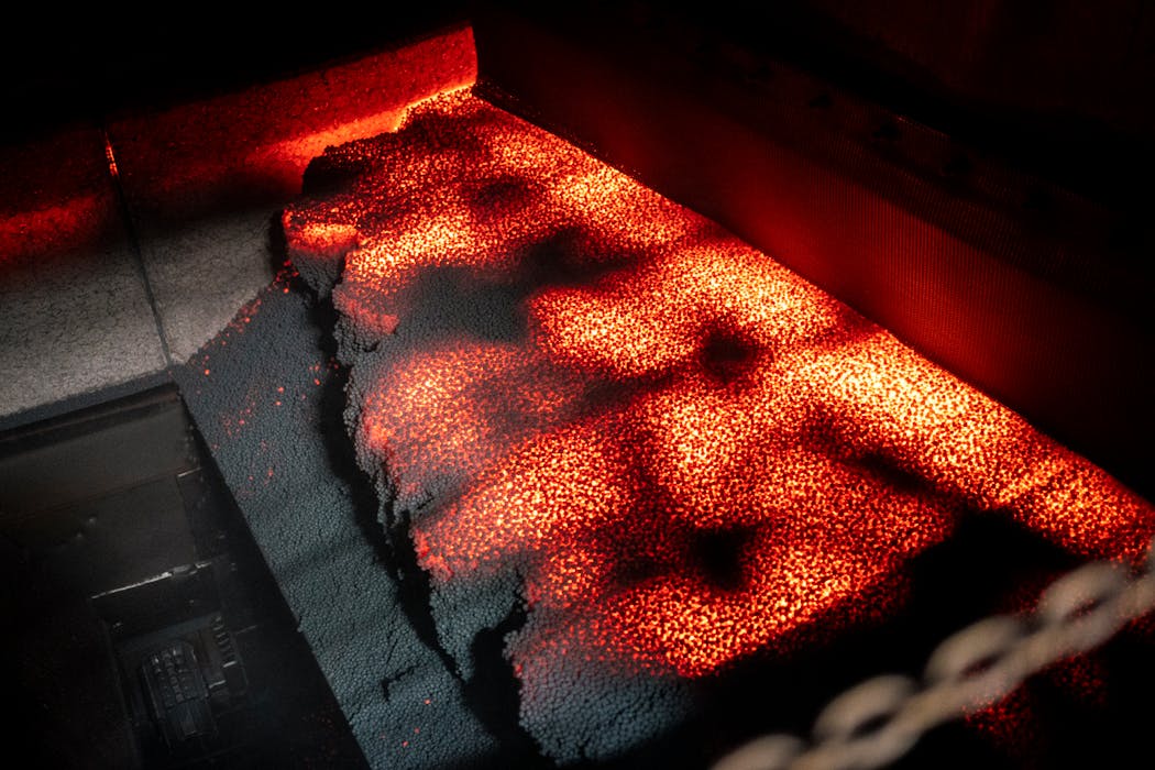 Iron pellets emerge from the furnace at U.S. Steel’s Keetac taconite plant in Keewatin, Minn.