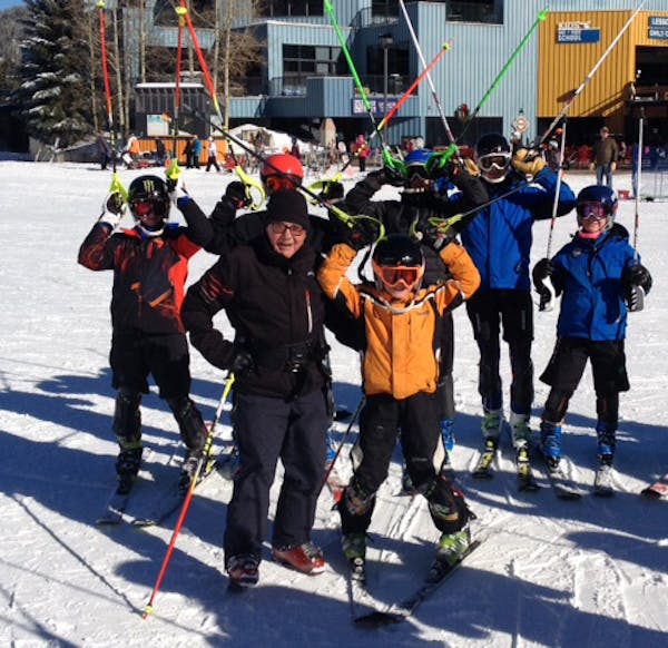 Ski coach Erich Sailer, left, is shown recently with some of his young charges in Colorado.