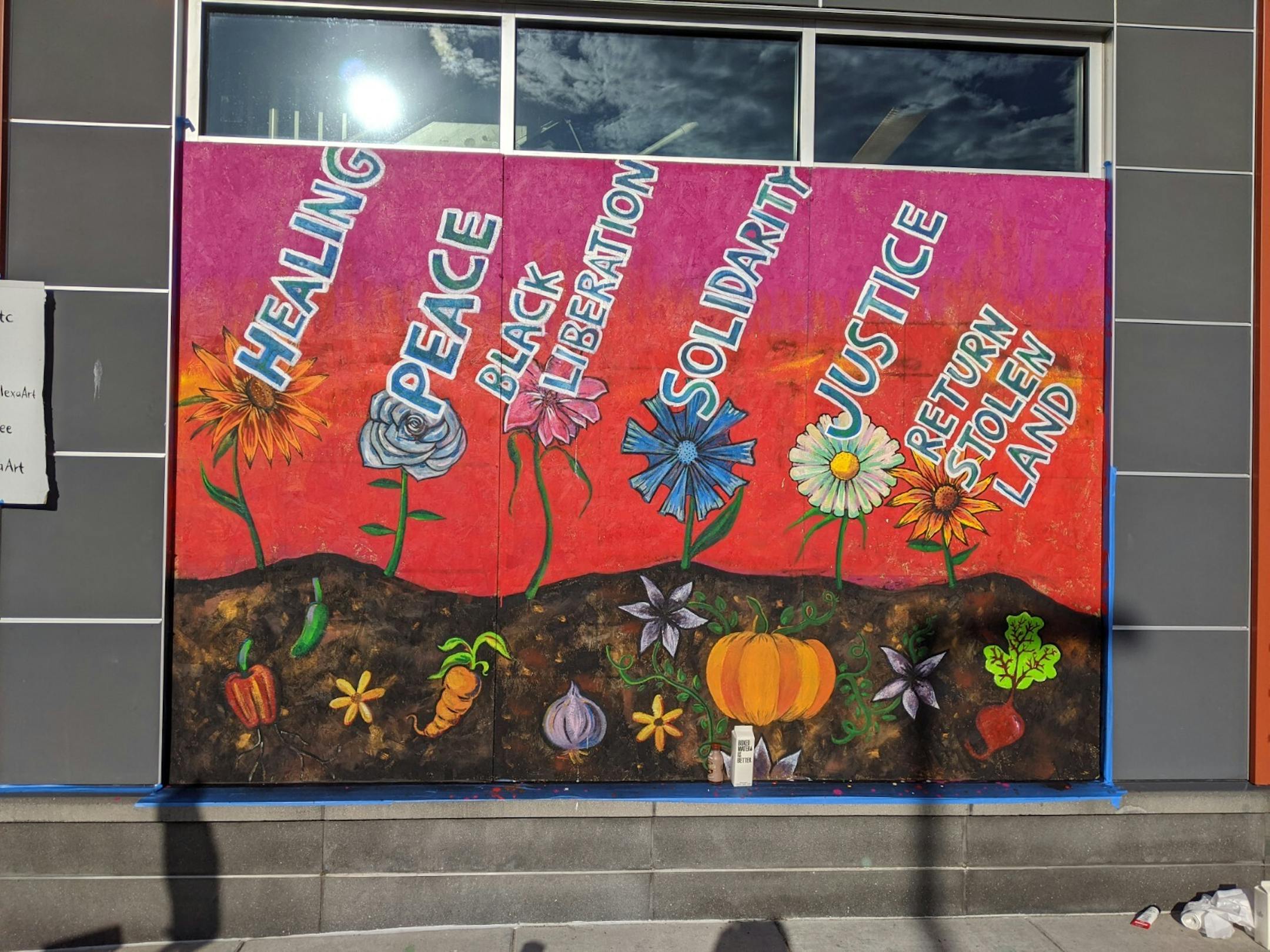 A mural on the boarded-up windows of Seward Co-op, located at 317 E. 38th St., just blocks from where Floyd was killed, expresses wishes for solidarity, healing, justice, and indigenous rights at Seward Co-op.