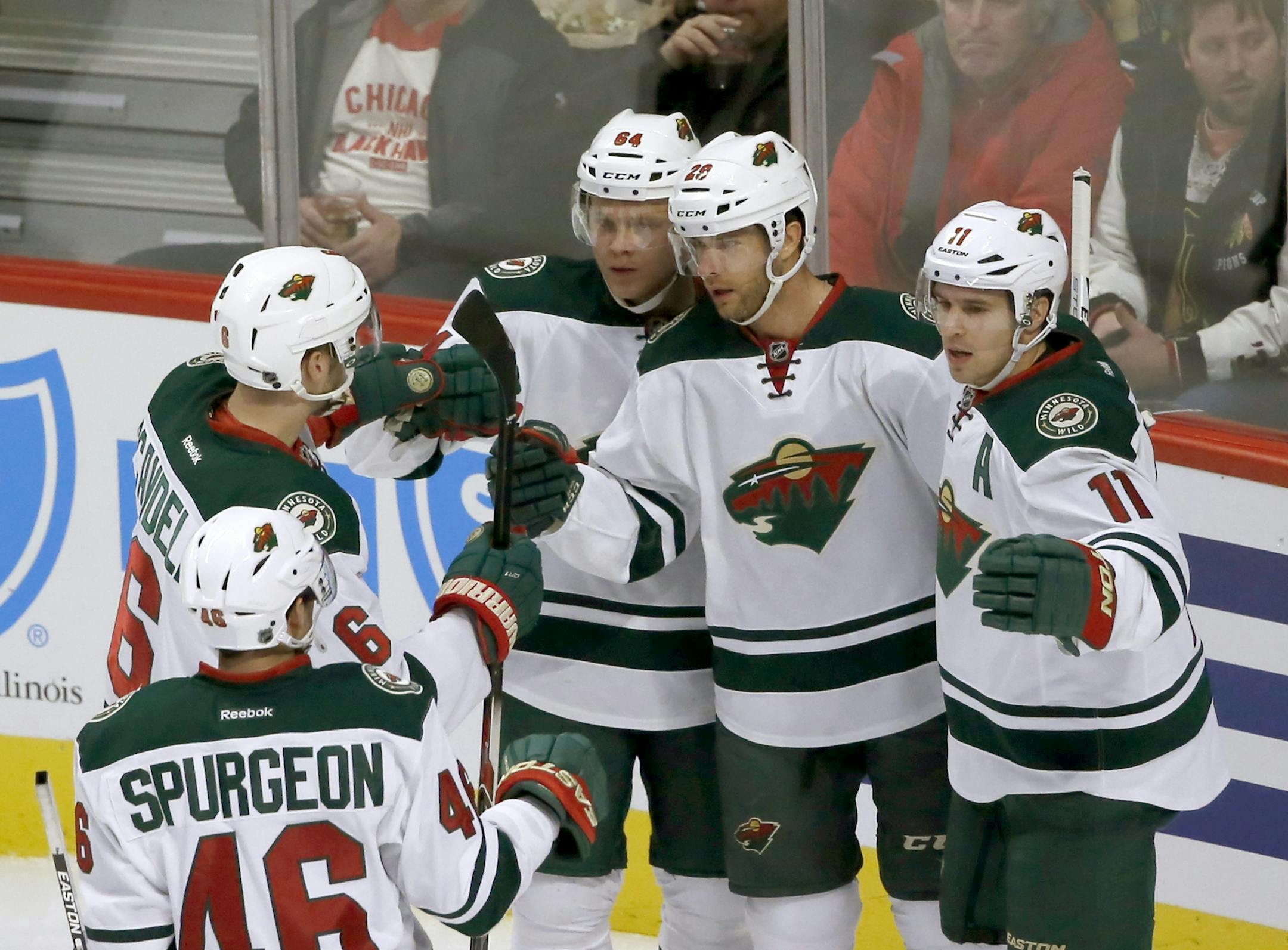 Wild right winger Jason Pominville, second from right, celebrated with teammates Jared Spurgeon, Marco Scandella, Mikael Granlund, and Zach Parise after Pominville's first-period goal in a 2-1 victory over the Blackhawks in Chicago.