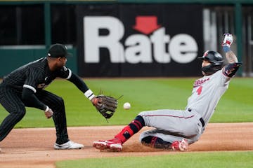 Carlos Correa slides into second base during a game last season.