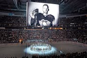 The Pittsburgh Penguins and Anaheim Ducks gather at center ice, before an NHL hockey game in Pittsburgh, Monday, Oct. 30, 2023, to honor former Pengui