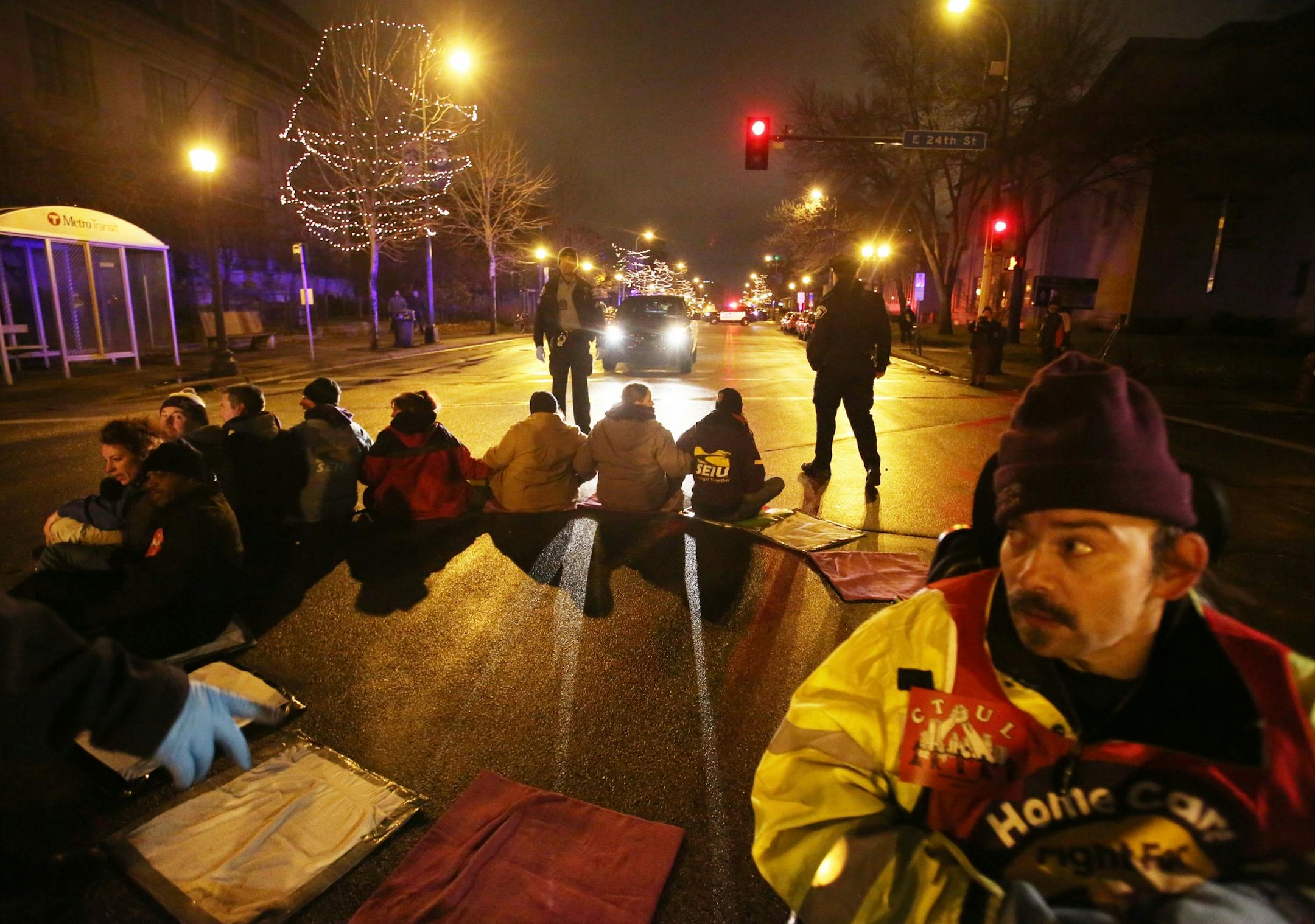 Protestors for Nationwide Fight for $15 Day of Disruption gathered outside McDonald's at 24th St. E. and Franklin Avenue, where for about a half hour protestors sat in a circle and blocked the intersection until they were arrested by Minneapolis police Tuesday, Nov. 29, 2016, in Minneapolis, MN. Here, Darrell Paulsen of Maplewood, right, who sat in his wheelchair, waited with other protestors to be taken into custody taken after protestors sat and blocked the intersection at 24th St. E. and Fran