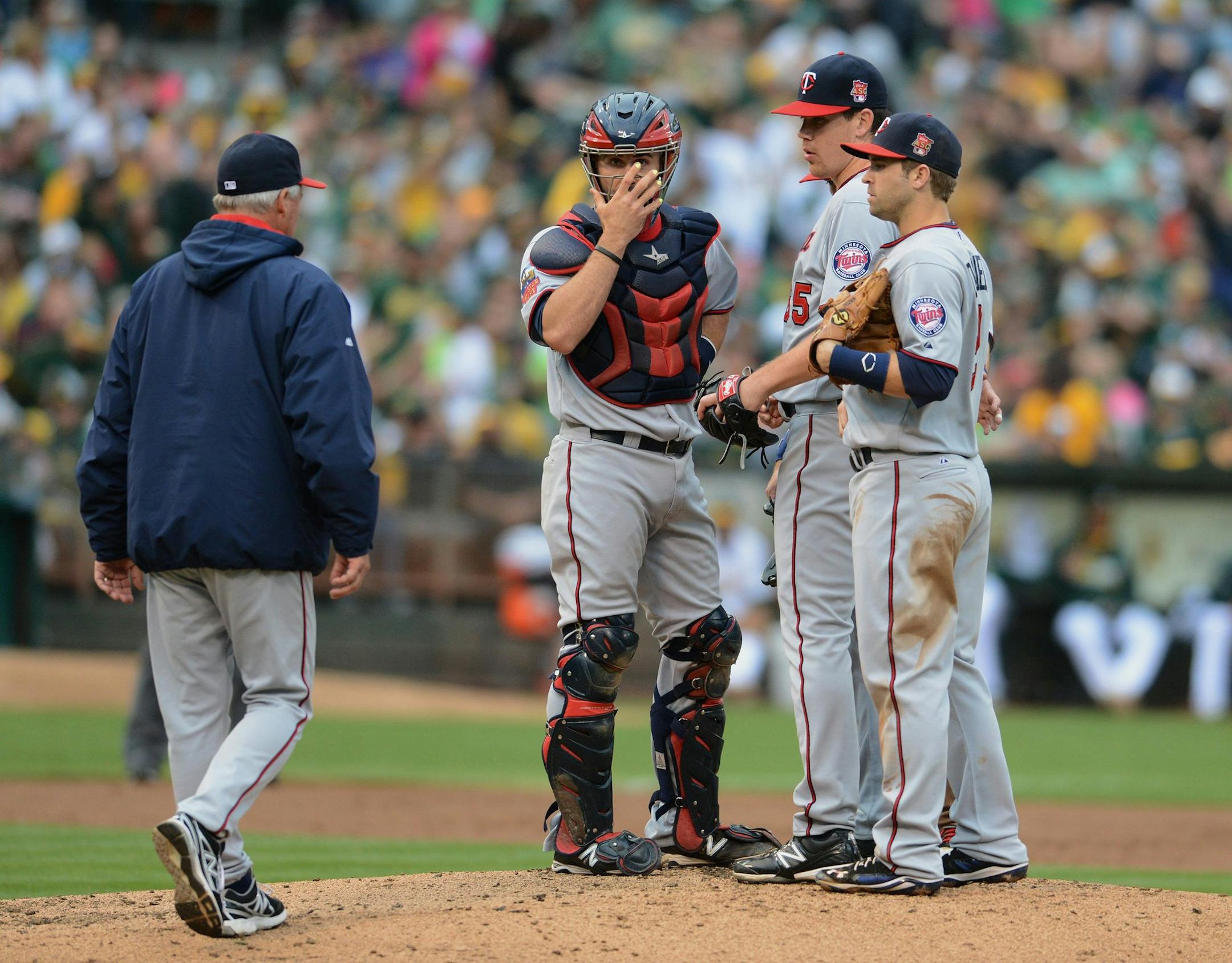 Minnesota Twins pitching coach Rick Anderson goes to the mound to visit pitcher Trevor May (65) in the first inning against the Oakland Athletics at O.co Coliseum in Oakland, Calif., on Saturday, Aug. 9, 2014. (Dan Honda/Bay Area News Group/MCT)