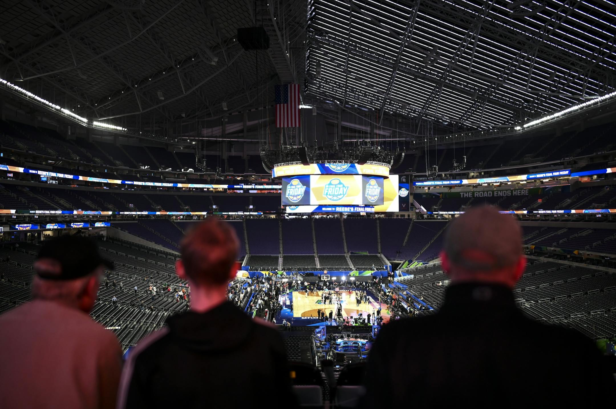 Fans took photos of the basketball court Friday as the teams practiced in front of thousands of fans at U.S. Bank Stadium