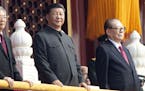 Chinese President Xi Jinping, center, with former presidents Jiang Zemin, right, and Hu Jintao, left, attend the celebration to commemorate the 70th a
