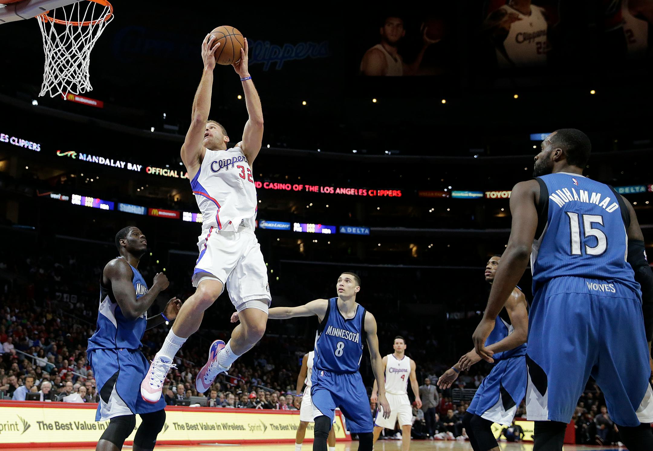 Los Angeles Clippers' Blake Griffin, top left, goes up for a dunk as the Minnesota Timberwolves players watch during the second half of an NBA basketball game Monday, Dec. 1, 2014, in Los Angeles. The Clippers won 127-101. (AP Photo/Jae C. Hong)