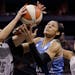 San Antonio Stars' Becky Hammon (25) steals the ball from Minnesota Lynx's Maya Moore, center, during the first half in Game 2 of the WNBA basketball 