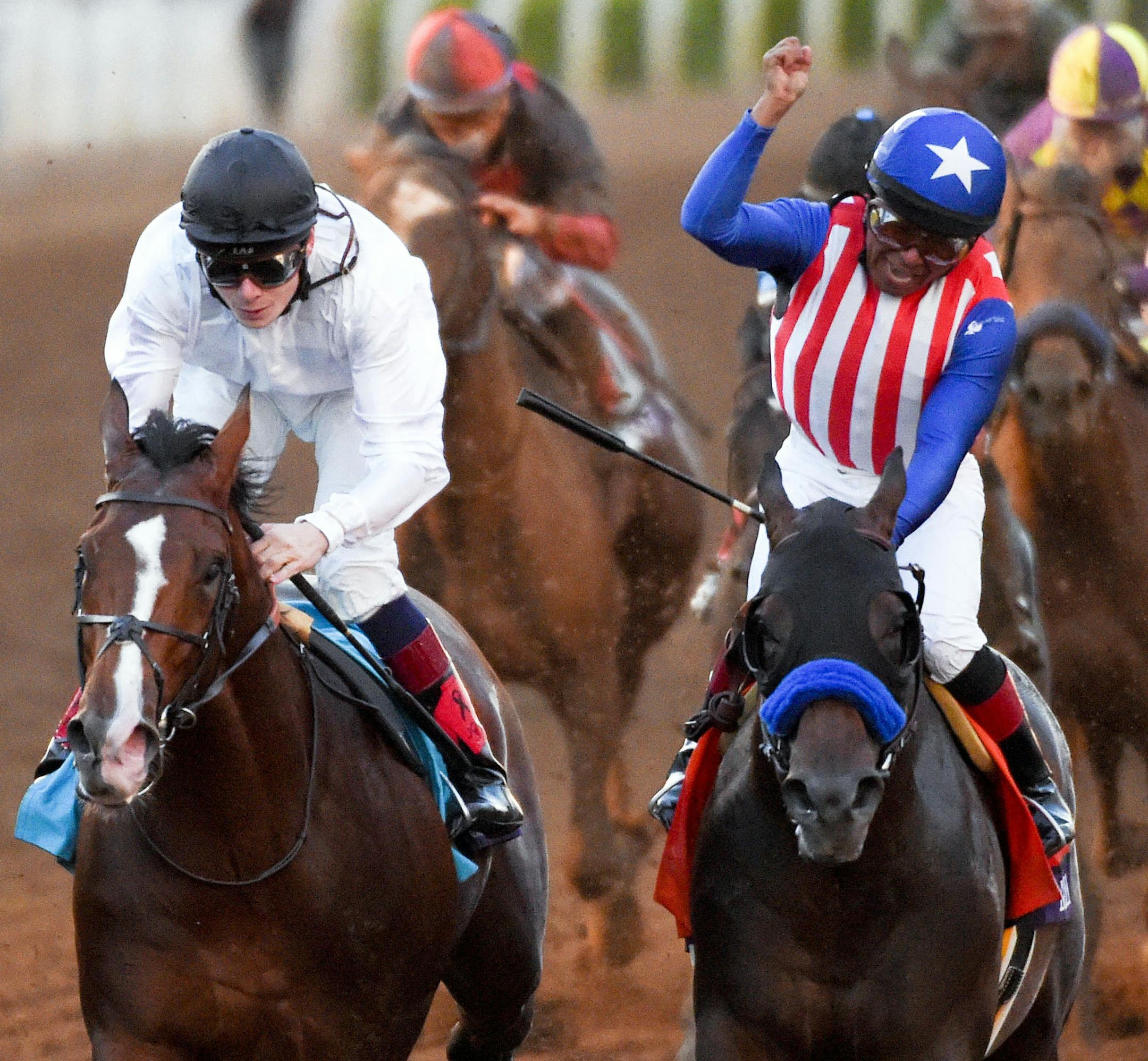 Jockey Martin Garcia celebrates after riding Bayern, right, to victory in the Breeders' Cup Classic horse race past jockey Jamie Spencer on Toast of New York at Santa Anita Park, Saturday, Nov. 1, 2014, in Arcadia, Calif. (AP Photo/Mark J. Terrill)