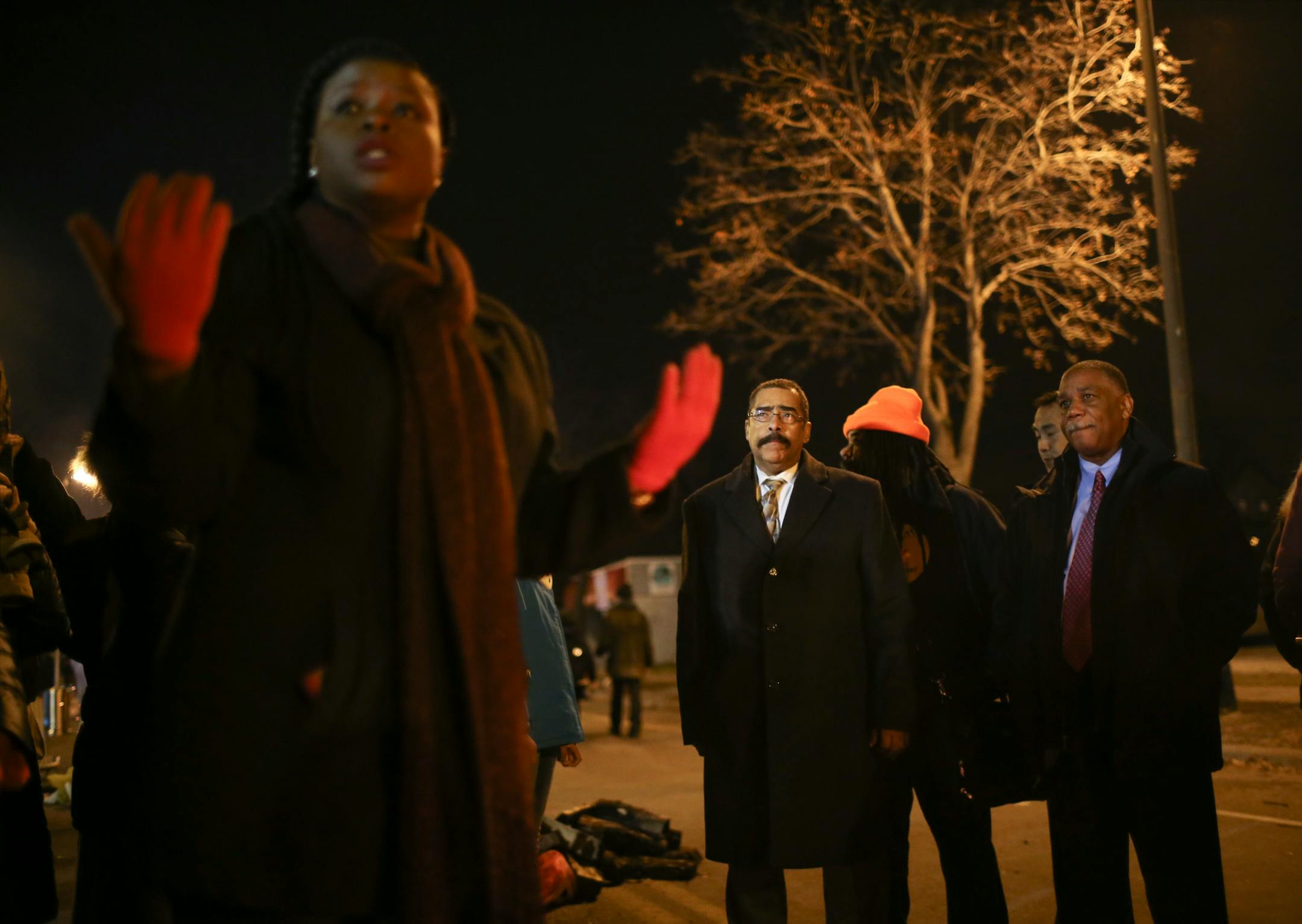 Minneapolis NAAACP President Nekima Levy-Pounds, left, spoke with two men who said they were with the Department of Justice Wednesday night outside the Fourth Precinct police headquarters. She asked if anyone wanted to address them while they were there and and a few people came forward to do so. They then asked Levy-Pounds if they could go somewhere else to speak privately and they did.