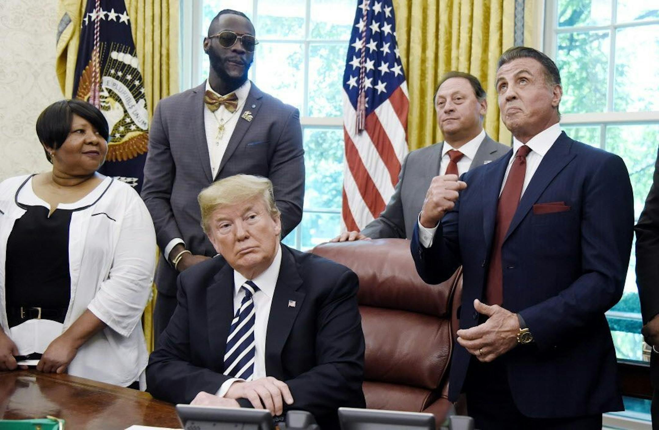 Actor Sylvester Stallone gestures during a signing ceremony to grant posthumous pardon to former heavyweight champion Jack Johnson in the Oval Office of the White House on May 24, 2018 in Washington, D.C.