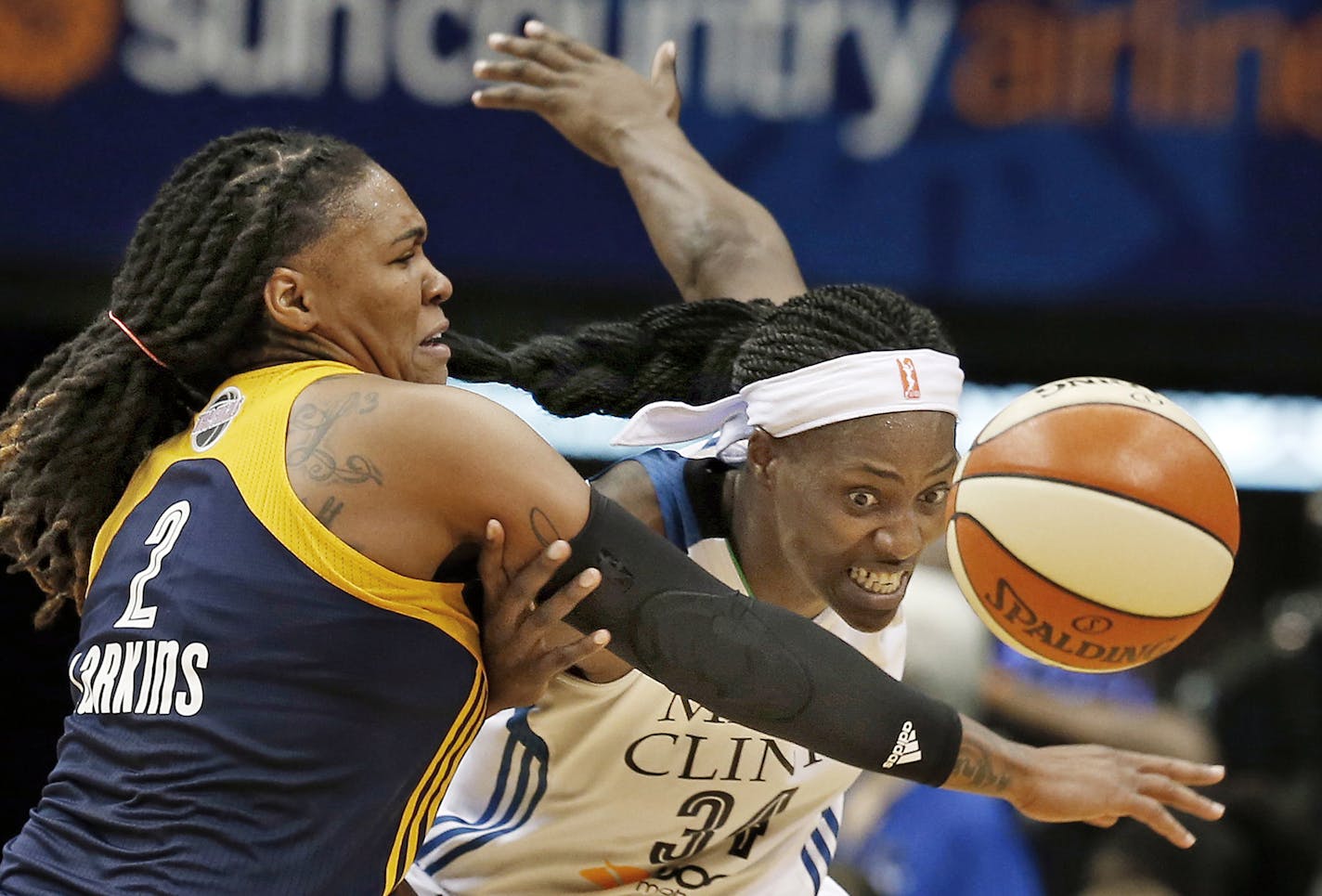 Indiana Fever&#xcc;s Erlana Larkins, left, tries to keep Minnesota Lynx&#xcc;s Sylvia Fowles away from the ball in the second half in Game 1 of the WNBA basketball finals, Sunday, Oct. 4, 2015, in Minneapolis. The Fever won 75-69. (AP Photo/Jim Mone) ORG XMIT: MIN2015101618585758