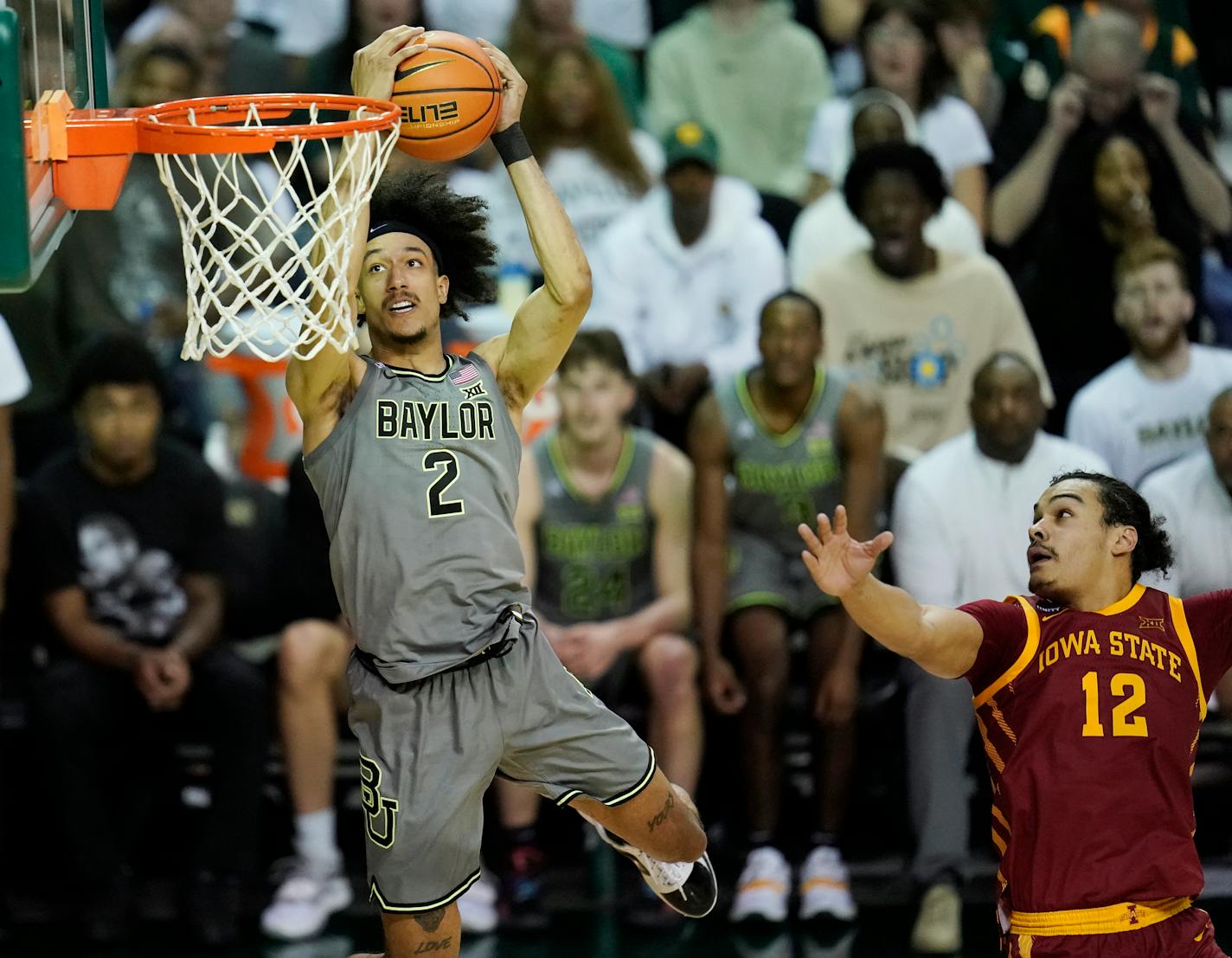 Baylor guard Kendall Brown, left, dunks over Iowa State forward Robert Jones, right, in the second half of an NCAA college basketball game, Saturday, March 5, 2022, in Waco, Texas. (Chris Jones/Waco Tribune-Herald via AP)