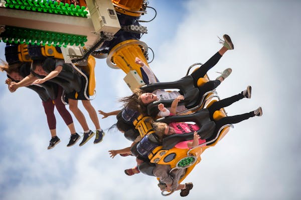 Fairgoers enjoy the Rock It ride on the Mighty Midway at the Minnesota State Fair.