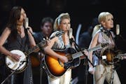 The Dixie Chicks, from left, Emily Robison, Natalie Maines and Martie Maguire perform the song "Landslide" at the 45th Annual Grammy Awards, Sunday, F