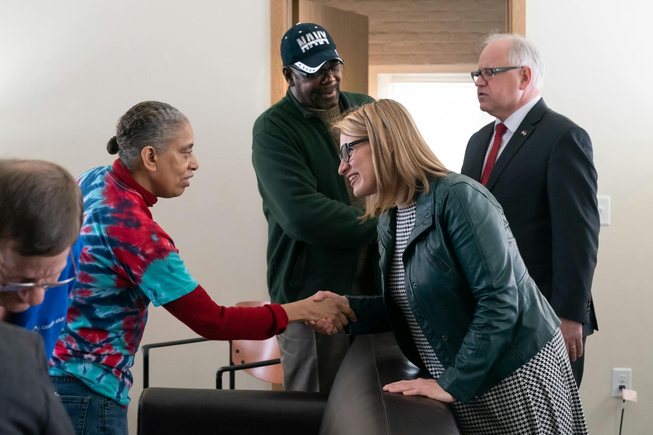 Lieutenant Governor Peggy Flanagan talked with resident Rochelle James while Governor Tim Walz talked with Marvin Jarnagin. They toured the Upper Post Veterans Community at Fort Snelling, remodeled as a place to live for formerly homeless veterans. He touted it as an example of important and appropriate investments in Minnesota as he released his $1.3 billion bonding proposal.