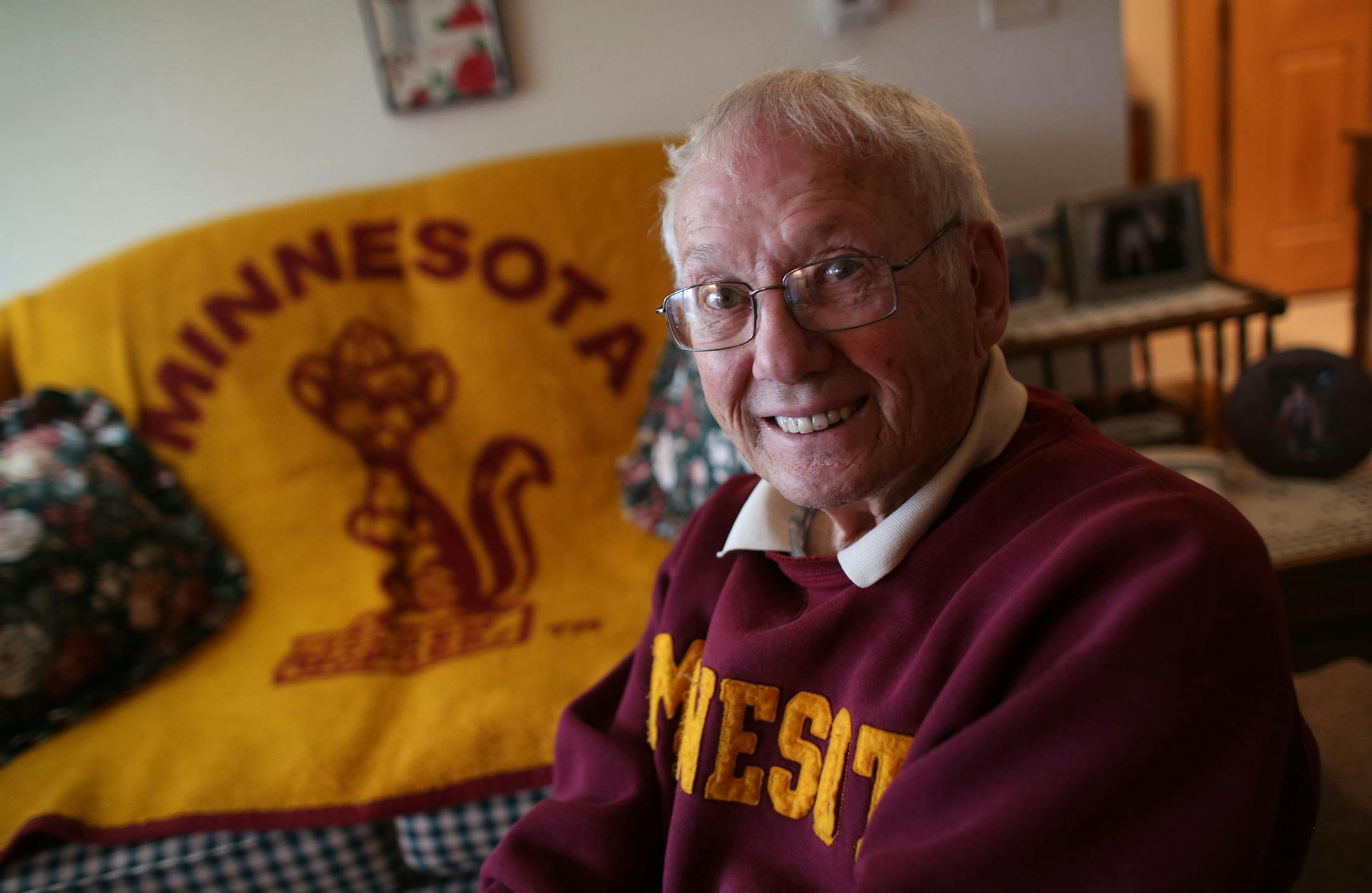 Andy Dyrdal, 91, a Gopher fan since he was 11, sat in his living room with his Gopher memorabilia. Dyrdal planned to go to the Citrus Bowl. ] (KYNDELL HARKNESS/STAR TRIBUNE) kyndell.harkness@startribune.com At the home of Gopher fan Andy Dyrdal in Albert Lea Min., Tuesday, December 16, 2014. Dyrdal was at the last major bowl game for the Gophers, the 1962 Rose Bowl