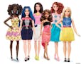 This photo provided by Mattel shows a group of new Barbie dolls introduced in January 2016. Mattel, the maker of the famous plastic doll, said it will