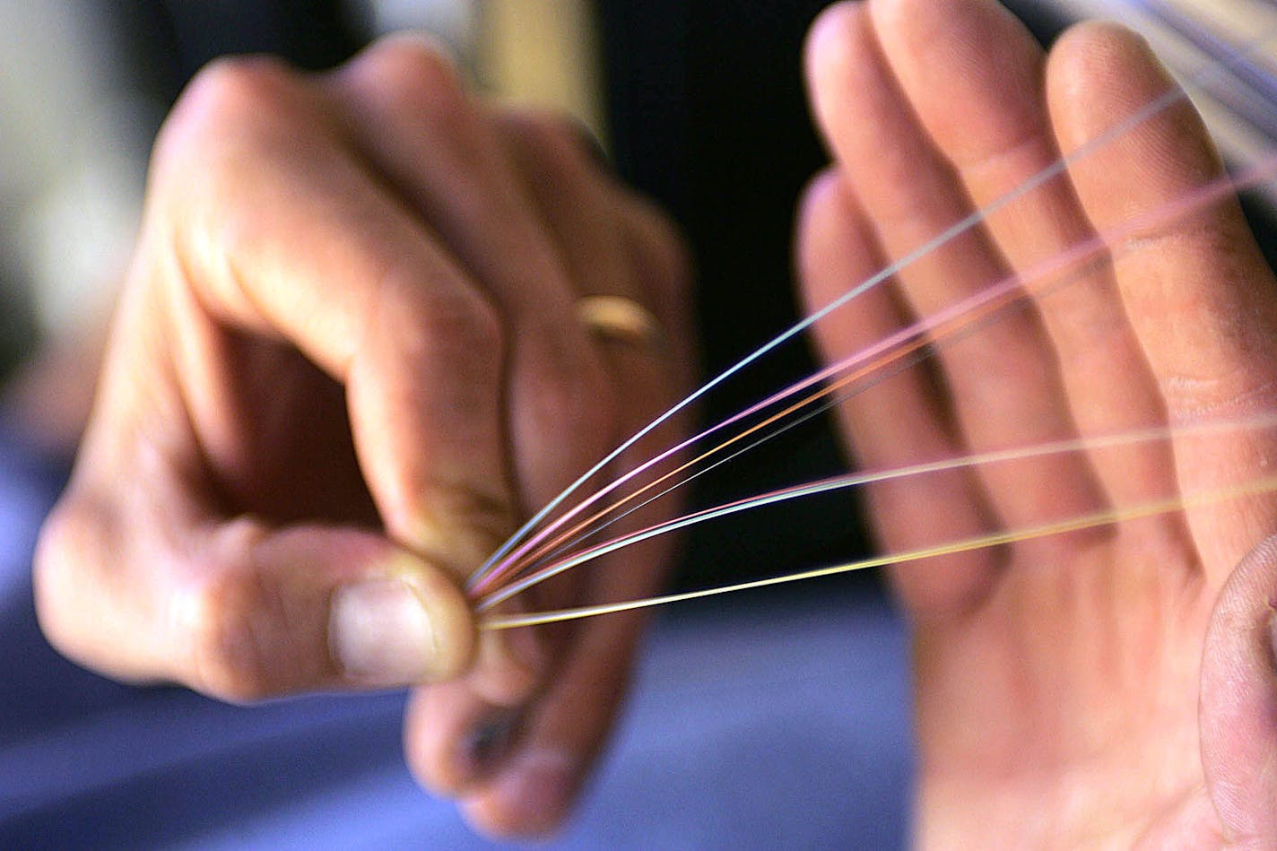 Bryon McCord, a Verizon spicing technician, holds part of a 96 fiber optic cable in Fairfax County, Virginia on October 25, 2004. Verizon is replacing copper cabling with the fiber-based one so they can offer potentially lucrative new services such as video-on-demand and superfast Internet access. Photographer: Dennis Brack/ Bloomberg News.