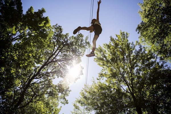 A customer rides one of the six zip lines at Trollhaugen Aerial Adventure Park in Dresser, Wis. on Thursday, July 30, 2015.