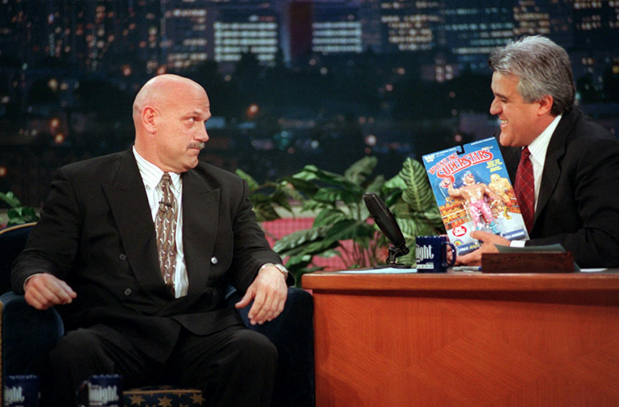 Minnesota Governor-elect and former professional wrestler Jesse Ventura, left, reacts to getting razzed by Tonight Show host Jay Leno who holds a Jesse "The Body" Ventura action-figure doll, during taping in Burbank, Calif., Tuesday, Nov. 17, 1998.