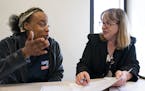 Kamarra Johnson meets with attorney Barbara White, right, an attorney with Target Corp. during an eviction expungement legal clinic. Johnson is trying
