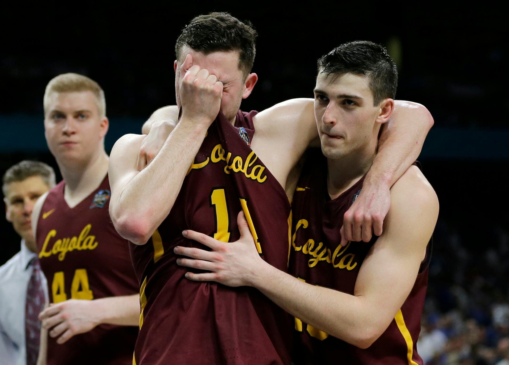 Loyola-Chicago's Ben Richardson embraces with Clayton Custer, right, after the semifinals of the Final Four NCAA college basketball tournament against Michigan, Saturday, March 31, 2018, in San Antonio. Michigan won 69-57. (AP Photo/David J. Phillip)