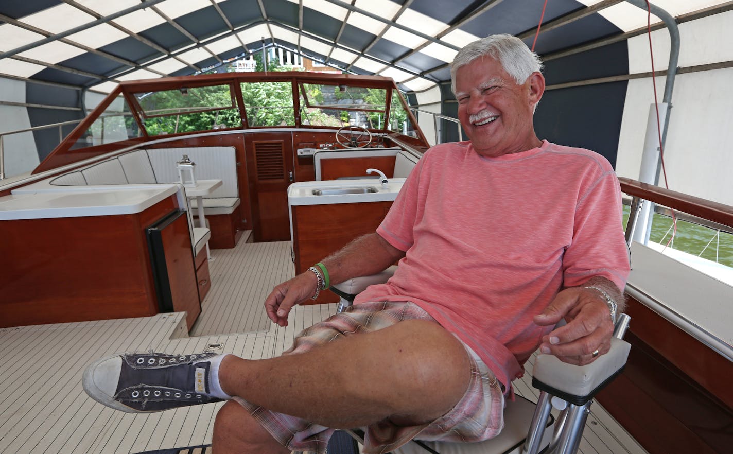 Bob Emfield of Orono, one of the founders of the Tommy Bahama menswear line, relaxed on his 31-foot Skiff Craft boat on Lake Minnetonka.