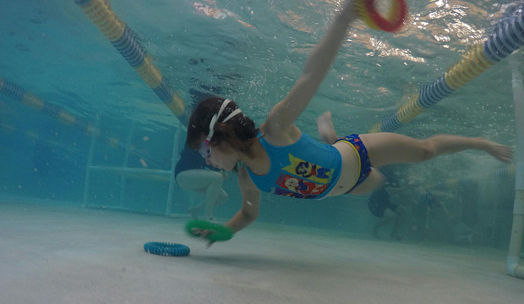 A swim student dives for rings as part of a game played at the end of her class on Monday. ] ALEX KORMANN • alex.kormann@startribune.com Foss Swimming School has gained a huge following in the Twin Cities and surrounding areas. There are seven (soon to be eight) locations throughout Minnesota. At the Chanhassen location, swim instructors bring a seemingly never ending level of energy as they teach back to back classes for hours on end. The kids they teach vary in age and skill level and t