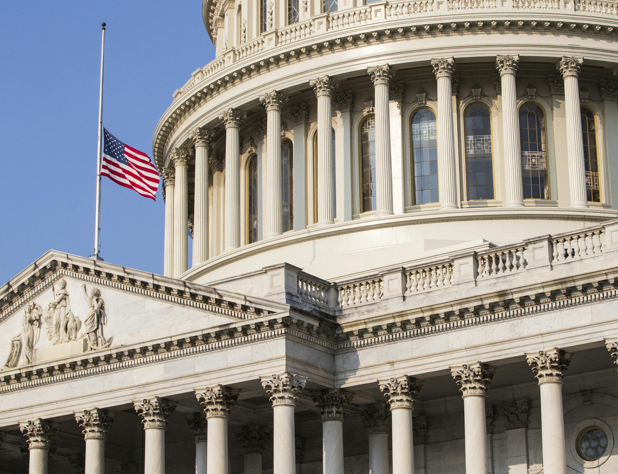 The American flag flies at half-staff at the Capitol in honor of Sen. John McCain of Arizona who died Saturday of brain cancer, in Washington, Monday, Aug. 27, 2018. McCain will lie in state in the Capitol Rotunda on Friday. (AP Photo/J. Scott Applewhite)