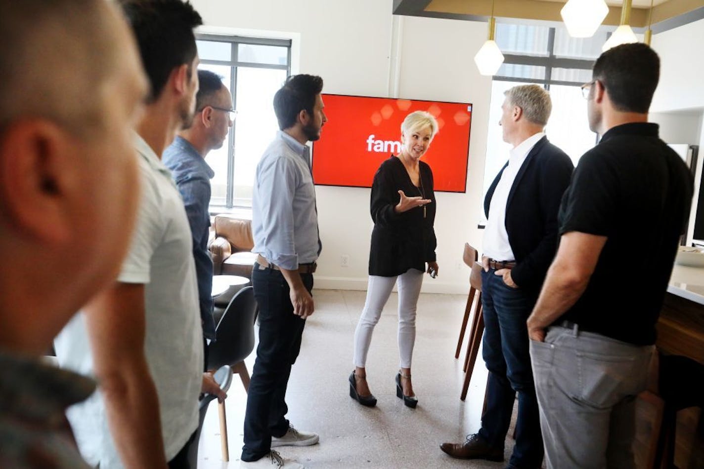 Lynne Robertson, CEO and owner of Fame, center, chatted with employees and clients at Fame Wednesday, Aug. 1, 2018, in Minneapolis, MN.